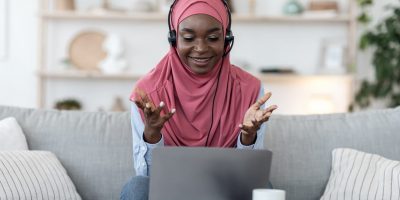 a woman wearing a hijab interacting on her computer